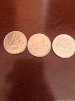 Reverse sides of three Canadian silver dollar coins showing the iconic Canoe design with dates 1968, 1975, and 1980