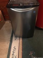 Front view of Kalorik bar fridge showing stainless steel door and control panel at top.