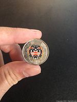 Front side of the coin showing the colored Indigenous art design.