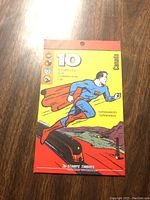Front of original sealed package showing Superman flying over train and number 10 indicating stamp quantity