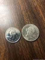 Canadian Sir John A. MacDonald commemorative dollar 1997 obverse and American Bicentennial dollar reverse showing Liberty Bell and moon.