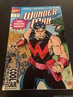 Front cover image of the Wonder Man comic book titled 'Lights, Cameras & Action!' showing character in red and black costume and background details.