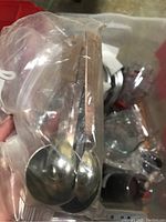 Photo of metal measuring spoons in plastic packaging