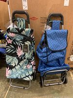 Two grocery carts with bags, one with tropical floral pattern, one with blue geometric pattern.