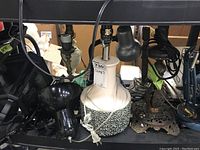 Five lamps including a ceramic table lamp with floral base, metal decorative outdoor lamp, and multiple desk lamps in black and blue metal/plastic.