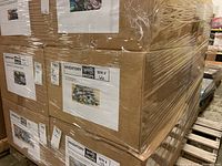 Photo of sealed cardboard boxes wrapped in plastic on pallet indicating inventory for mugs.