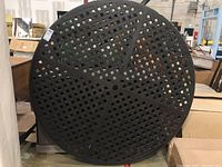 Image showing the top of the round patio table with lattice metal surface in black coating.