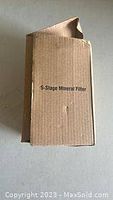Plain cardboard box labeled '5-Stage Mineral Filter', slightly crumpled at the top.