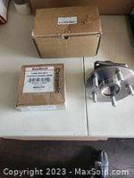 Photo showing ceramic brake caliper part in original box alongside another cardboard box