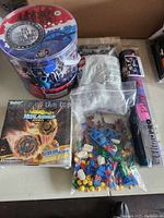 Overview of the lot showing Civil War soldier figures container, LEGO bags, Metal Assembly Gyro toy box, and Ultimate Pro Play Mat in packaging.