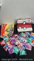 Full lot of items including Nintendo Switch cases, hidden pictures books, and mini pop-it keychains all arranged together.