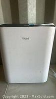 Front angled view of white Levoit air purifier unit