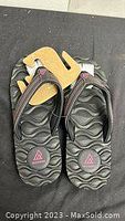 Top view of brand new black Ripzone men's size 10 sandals showing contoured wavy footbed and strap detail.