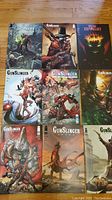 Nine comic books laid out on floor including seven Gunslinger comics and two King Spawn comics arranged in rows
