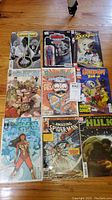 Photo of 9 varied comic books including licensed titles as Star Wars, Duck Tales, Scooby Doo, Wonder Girl, Hulk, and The Amazing Spider-Man.