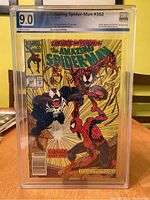 Front cover of the graded Amazing Spider-Man #362 comic book showing Spider-Man, Venom, and Carnage in action, graded 9.0 by PGX.