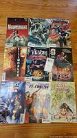Full view of nine Marvel comic books arranged on floor showing titles and characters