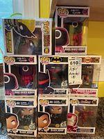 Seven unopened Pop! vinyl figures from various franchises: two Squid Game Round: Masked Worker, two DC Black Adam, one DC Hellbat, one Marvel Iron Man, all in original boxes.