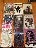 Overview of all nine comic books laid out showing covers including Thor, Wolverine, Radiant, Gideon Falls, Cloaked, and Primordial.