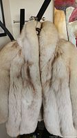 Full front view of the mink fur coat on hanger