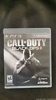 Front cover of Call of Duty Black Ops II game for PS3 showing game case and cover art