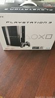 Original packaging box for Sony PlayStation 3 showing console and controller image, 80GB capacity stated.