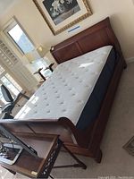 Full overview of assembled sleigh bed frame with mattress placeholder