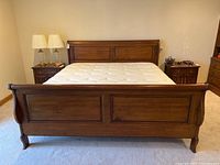 Front view of entire sleigh bed frame with mattress