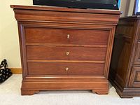 Front view of three-drawer chest showing overall appearance and drawer configuration