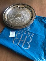 Serving tray on top of original blue Birks bag showing tray size and logo on bag