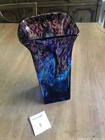Full view of the purple and blue K.A.G. art glass vase from the top angle showing the square flared opening and color patterns.