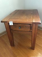 Full view of the solid oak end table showing sturdy legs, rectangular top with minor edge wear.