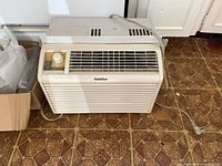 Front angled view of GoldStar window air conditioner showing grill and control knob.