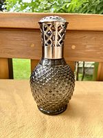 Front view of the textured glass Lampe Berger Paris fragrance lamp with lattice metal top.