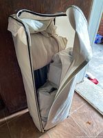 Carrying case open showing beige mattress and folded components inside