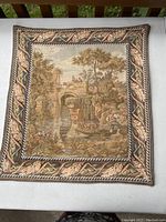 Full view of the tapestry showing detailed country pastoral scene with bordered leaf pattern