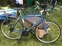 Left side view of the complete bike showing frame, wheels, saddle, and handlebars