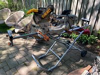 Overall lot showing saw mounted on stand with extension cord