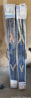Two new in box Mastercraft metal sawhorses wrapped in plastic with visible blue metal frames and folding legs.