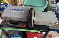 Closed Dremel Multi-Max case and Kreg blue drill accessories cases on a surface