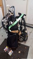 Full set of clubs in bag with trolley and boxed balls at base