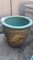 Full view of the planter showing the wide mouth and exterior dragon design with gold horizontal stripes.