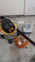 Ridgid 5 HP 45L Shop Vac, Patton space heater, and extension cord on concrete floor