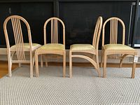 Front view of all four chairs side by side on rug
