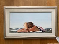 Full frontal view of painting in frame on wooden floor