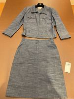 Front view of jacket and skirt laid flat on surface