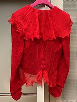 Back of red jacket showing boned leather corset tie-up closure