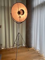 Full view of lamp lit, showing height and tripod support