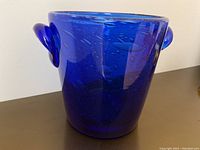 Full side view of glass bucket showing color, shape, and handles