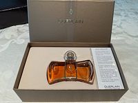 Open gift box showing crystal perfume bottle and informational card